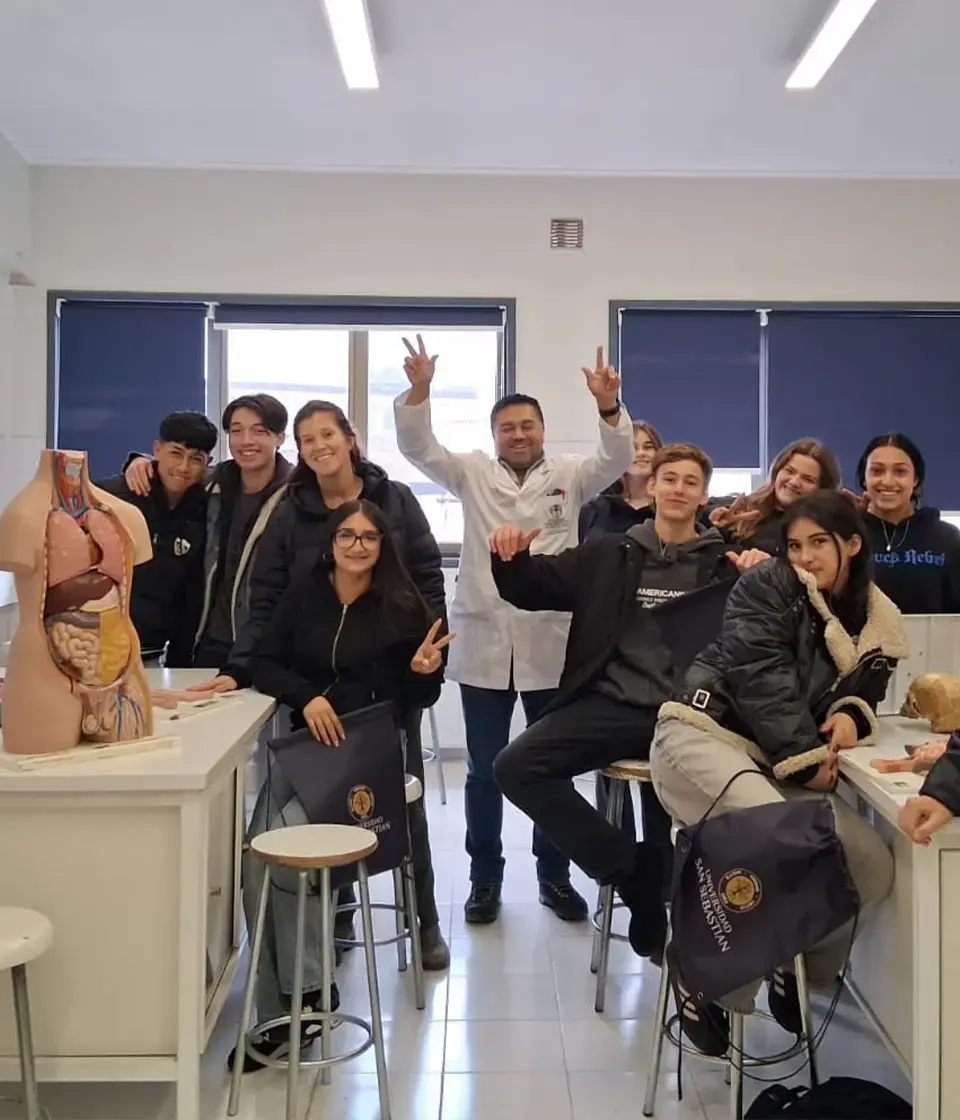Grupo de alumnos y profesor posando sonrientes en un laboratorio escolar. Grupo de alumnos y profesor posando sonrientes en un laboratorio escolar.